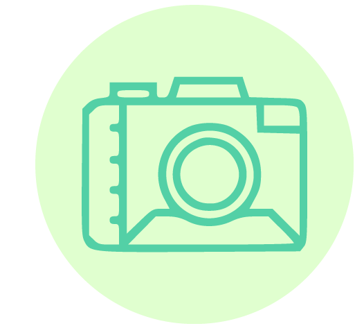 A simple green line drawing of a camera is centered on a light, mint-green circular background. The camera features a prominent lens and basic outline, evoking a minimalistic and modern style.