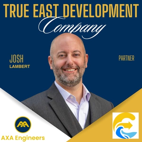 AXA Engineers | Award-winning Civil Engineering Outsourcing Solutions 57 Civil Engineering Outsourcing A smiling bald man with a beard in a gray suit, featured in a civil engineering outsourcing testimonial for True East Development.