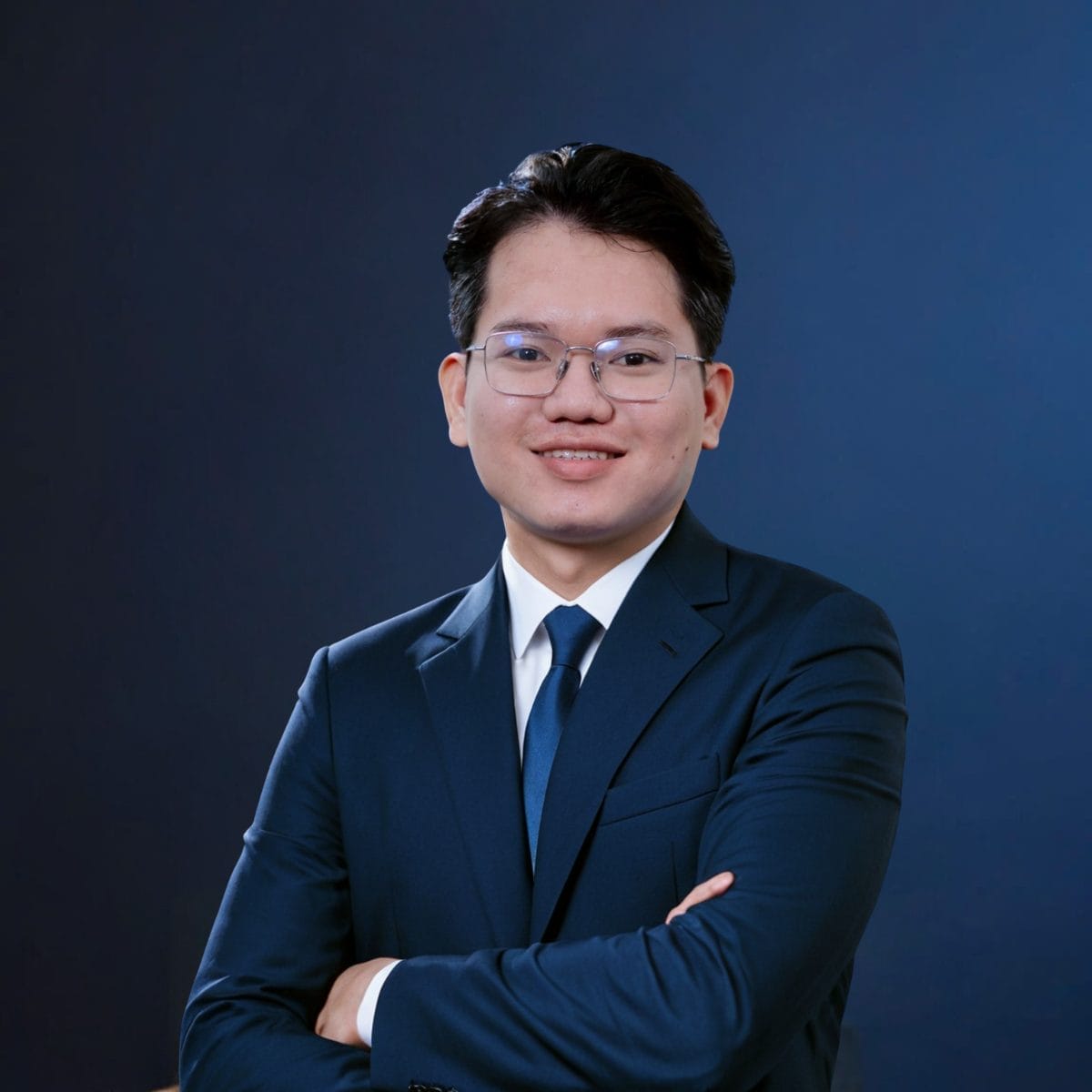 Civil Engineering Outsourcing A confident young man in glasses and a navy blue suit stands with arms crossed, embodying leadership for Civil Engineering Outsourcing.