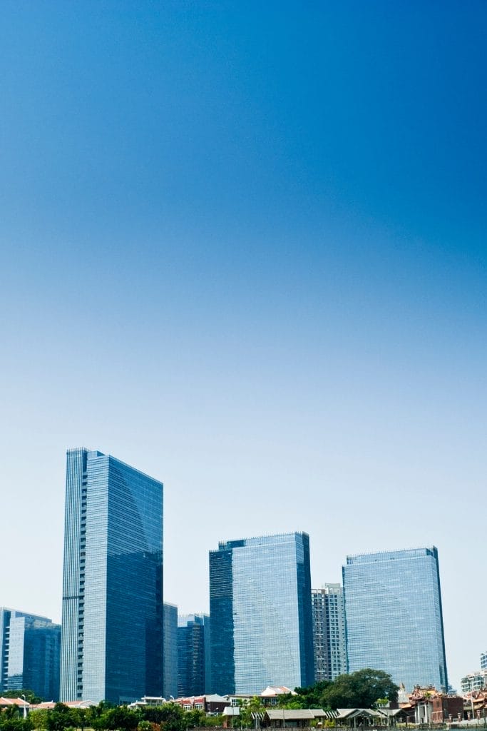 Civil Engineering Outsourcing Modern glass high-rise office buildings reflect the sky, highlighting our civil engineering outsourcing expertise in urban design.