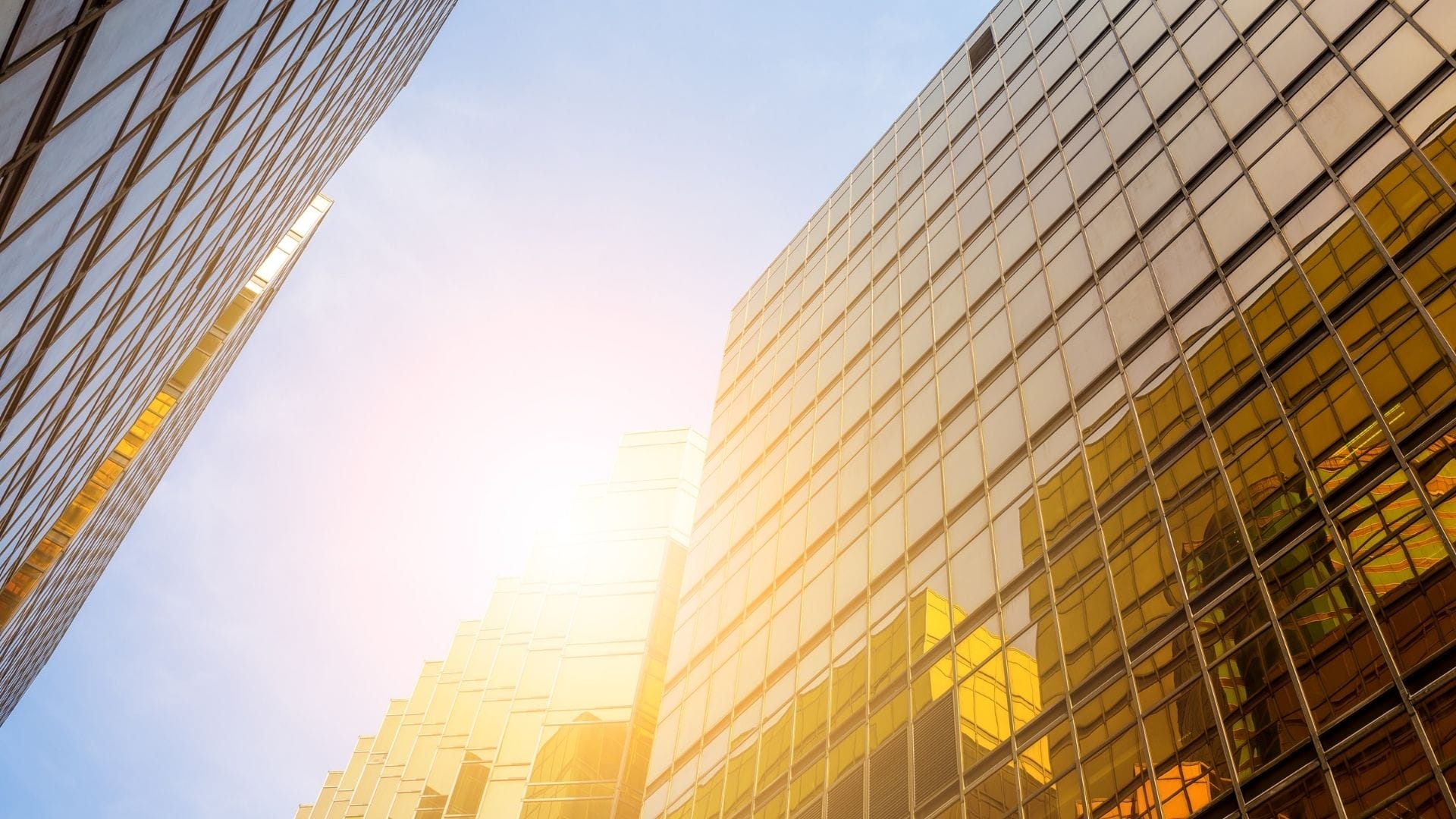 Civil Engineering Outsourcing Sunlight glints off glass windows of tall, modern skyscrapers—an urban scene shaped by civil engineering outsourcing brilliance.