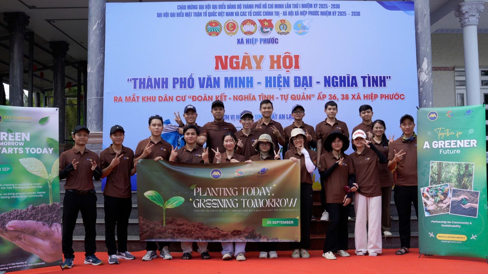 Civil Engineering Outsourcing A team in matching brown shirts and hats at an outdoor event holds green banners about civil engineering outsourcing and seeds.