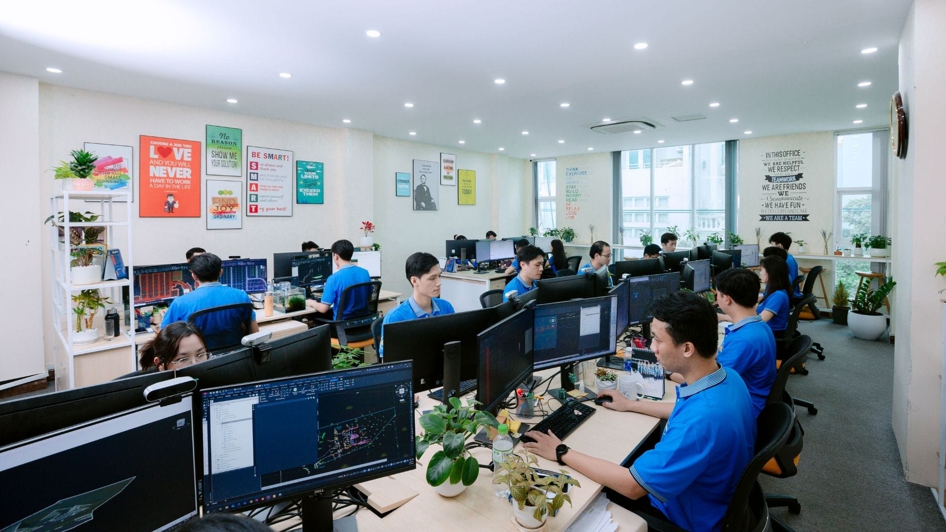 Civil Engineering Outsourcing A modern office where AXA’s civil engineering outsourcing team works, filled with monitors, colorful décor, and certification awards.